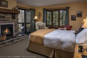 different from your competition guest room with bed in front of lit fireplace